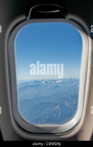 Close-up of window airplane with view over a range of mountains. Stock Photo