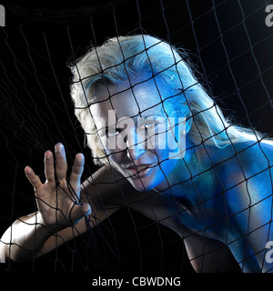 mystic mermaid theme showing a blue bodypainted woman posing with net in black back