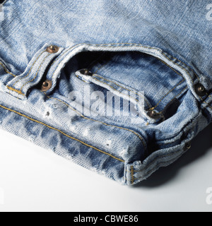 detail studio shot of a used pair of blue jeans in light back Stock Photo
