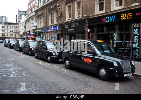 Taxi rank black cabs in a row waiting for customers Stock Photo