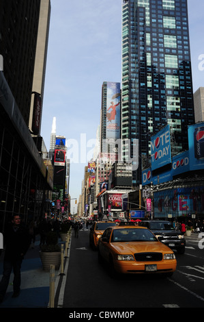 Blue sky 'urban alley' shade portrait yellow taxis, people, skyscrapers, theatre billboards, 7th Avenue, looking north, New York Stock Photo