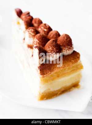 Portion of Tiramisu Mille crepe on a plate Stock Photo