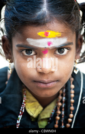 Poor Indian beggar girl dressed in religious hindu attire. Selective ...