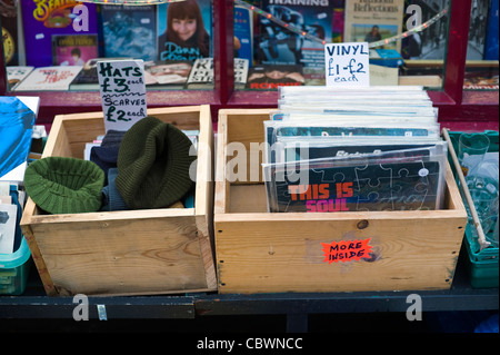 Cheap bargain box of hats scarfs and vinyl LPs for sale outside shop in Hay-on-Wye Powys Wales UK Stock Photo