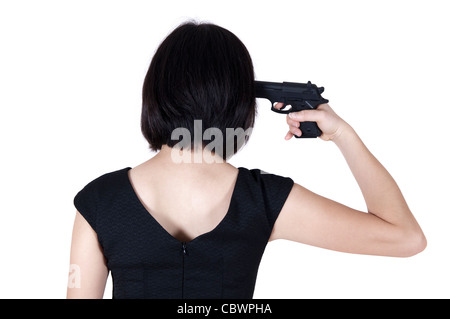 Woman with pistol pointing on her head, rear view isolated on white. Stock Photo