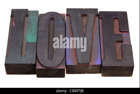 love word in antique wooden letterpress printing blocks, stained by color inks, isolated on white Stock Photo