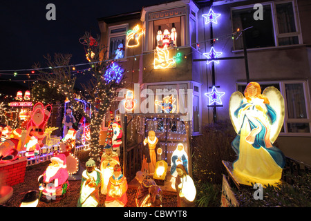 Illuminated electric Christmas lights, in garden of UK suburban house, Leiston, Suffolk, UK Stock Photo