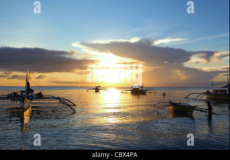 Outrigger fishing boats anchored off Donsol Beach at sunset. Donsol, Luzon, Albay, Bicol, Philippines, South-East Asia, Asia Stock Photo