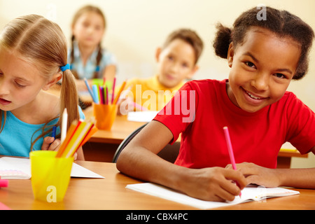 Portrait of lovely girl looking at camera at drawing lesson Stock Photo