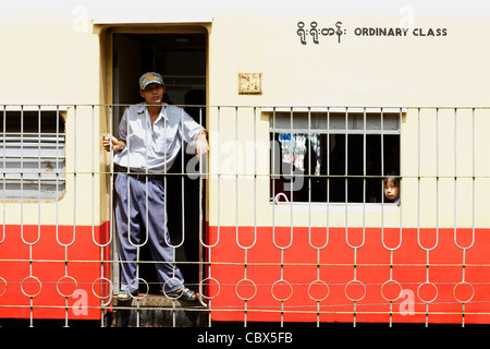 Passengers aboard a train in Yangon, Myanmar Stock Photo