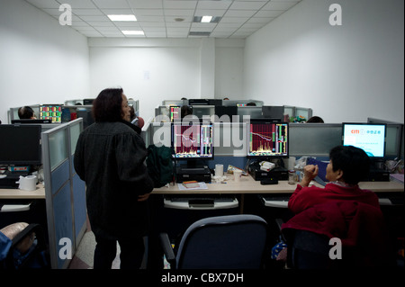 Beijing. CITIC Securities provides clients with dealing rooms for trading shares. Stock Photo