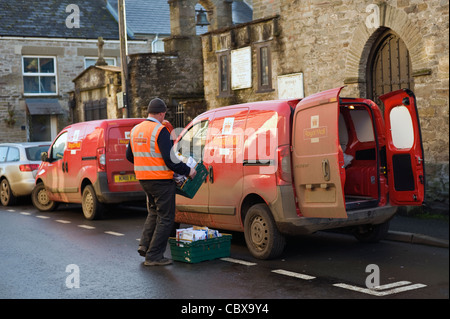 Postman loading delivery van in Hay-on-Wye Powys Wales UK Stock Photo