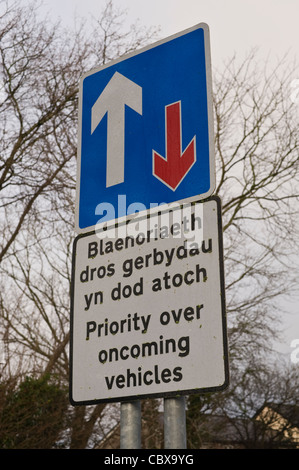 PRIORITY OVER ONCOMING VEHICLES bilingual Welsh English language road sign at Hay-on-Wye Powys Wales UK Stock Photo