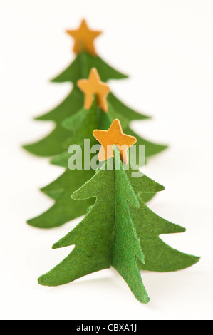 Three green paper Christmas trees with golden stars on tops Stock Photo