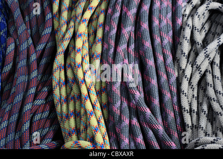 many old used rock climbing ropes in bundles Stock Photo