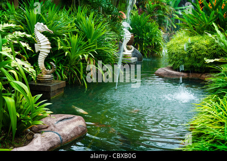 Tropical zen garden view with fountain and green plants. Stock Photo