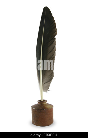 Feather quill pen in a circa 1830s to 1880s stoneware button inkwell. Stock Photo