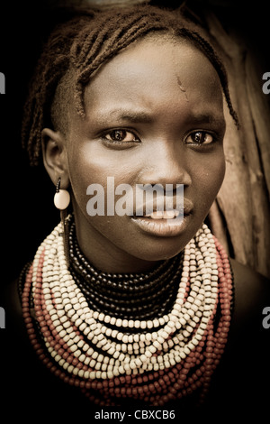 Striking portrait of a Galeb tribeswoman at a village on the Omo River near Omorate in the Lower Omo Valley, Southern Ethiopia. Stock Photo