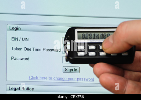 Man uses SecureID token to log into a website needing a userID, Passcode and Password Stock Photo
