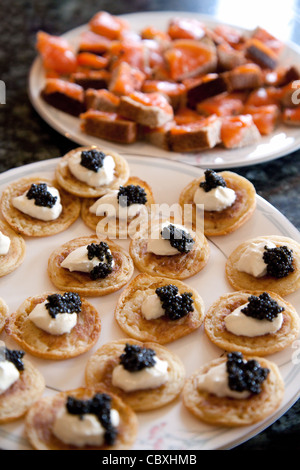 blinis with sour cream and caviar with smoked salmon on bread , Christmas food UK Stock Photo