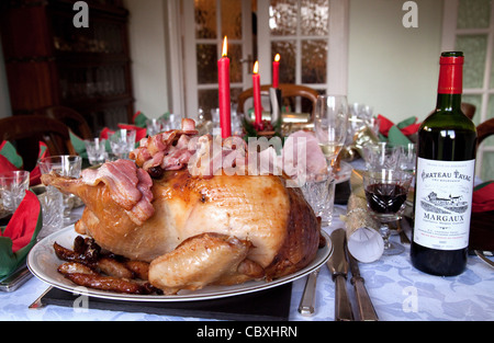 Roast turkey, claret and candles, a traditional christmas day dinner table, UK Stock Photo