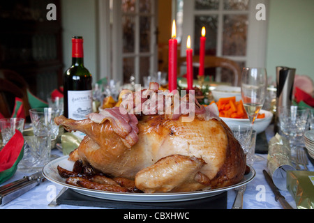 Roast turkey, claret and candles, a traditional christmas dinner table, UK Stock Photo