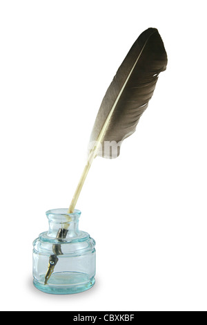 Feather quill pen in a circa 1890s to 1940s glass inkwell. Stock Photo