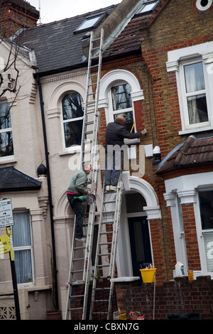 Workmen on Ladders on Exterior of London Home Stock Photo