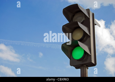 Green color on the traffic light with a beautiful blue sky in background