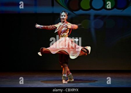 Asian Indian female dancer in spinning motion with swirling skirt Stock Photo