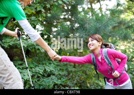 Young people go hiking in mountain Stock Photo