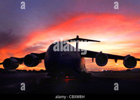 A C-17 Globemaster III sits on the flightline at Hickam Air Force Base, Hawaii, Sept. 30, 2009, as crews prepare to deliver humanitarian supplies to the Samoa region, which was devastated by a tsunami. A contingent from Hawaii, including Hawaii National Guard and Hawaii Air National Guard, took off for American Samoa with relief supplies and equipment to assist in the region. Stock Photo