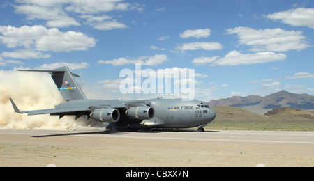 During the short take off and landing phase of the Mobility Air Forces Exercise, a C-17 Globemaster lII ands on a dirt landing zone at the Nevada Test and Training Range at Nellis Air Force Base, Nev. The 29th Weapons Squadron provides advanced tactical training to C-130 Hercules aircrew selected to attend the Weapons School here. The six-month, graduate-level course culminates in a massive airlift mission, called the Mobility Air Forces Exercise. More than 30 airlift assets and hundreds of support personnel from across the Air Force participate in the biannual training exercise. Stock Photo
