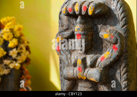 Hindu shrine stones at a temple depicting Indian vishnu deity in the south indian countryside. Andhra Pradesh, India Stock Photo