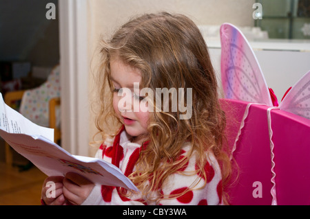 3 Year Old Child Girl Infant Toddler Reading a Book Stock Photo