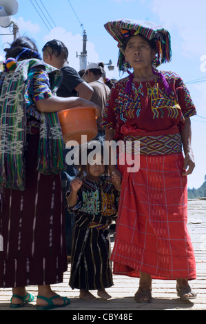 Indigenous Central American Indian women and a little girl in Guatemala wearing traditional woven clothing and head coverings. Stock Photo