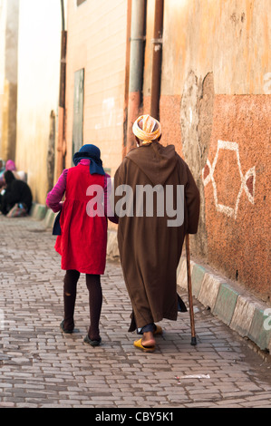 Man with girl walking through Medina, Marrakech,Morocco Stock Photo