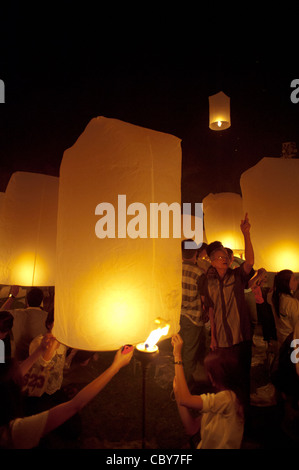 Traditional fire lanterns being released into the night sky during the Loi Krathongfestival in Chiang Mai, Thailand, Asia. Stock Photo