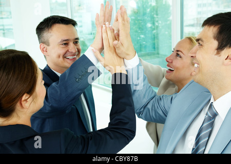Portrait of business group keeping hands close to each other meaning support Stock Photo