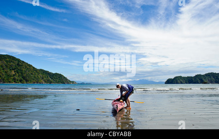 Woman beside sea kayak at the Curu Wildlife Refuge in Costa Rica Stock Photo