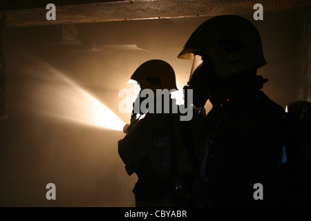 Firefighters in breathing apparatus BA BASCA are briefed before ...