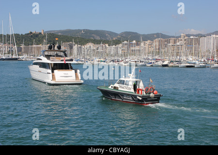 Scene in the Port of Palma de Mallorca - Practicos / Marine pilot launch following Sanlorenzo SL104 luxury superyacht Stock Photo