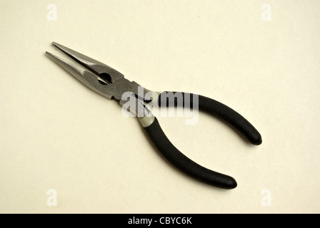 A pair of needle nose pliers sits on a white background Stock Photo
