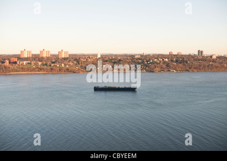 A barge on the Hudson River waits to be allowed to advance further down the river. Seen from the Palisades in New Jersey, USA. Stock Photo