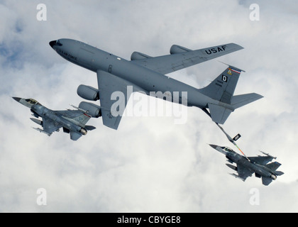 A KC-135 Stratotanker from Royal Air Force Mildenhall, England, refuels a pair of F-16 Fighting Falcons April 7 during a multinational exercise over the Baltic States. The Stratotankers from RAF Mildenhall feature the 'Box D' tail marking, dating back to World War II Stock Photo