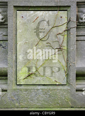 Conceptual grave with € and RIP engraved for symbolic death of European euro due to financial crisis and bank debt in Europe Stock Photo