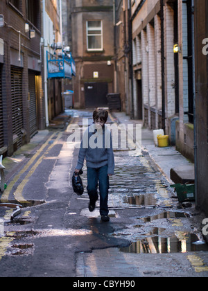 Young Boy in Narrow Alley, Glasgow Stock Photo
