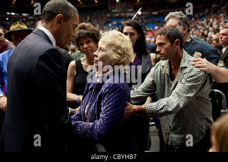 President Barack Obama speaks with Mavy Stoddard during a memorial service for the six victims who died in the shooting that injured Rep. Gabrielle Giffords Jan. 8, 2011 in Tucson, AZ. Stoddards husband Dorwan was one of those killed by the gunman. Stock Photo