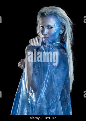 mystic mermaid theme showing a blond bodypainted woman coated with translucent blue fabrics, studio photography in black back
