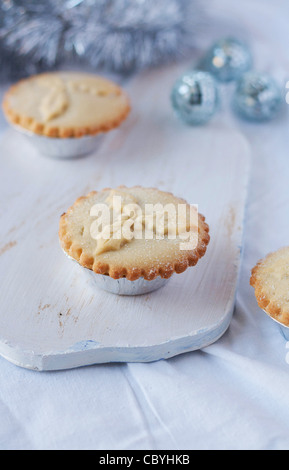 Homemade minced pies on a chopping board Stock Photo